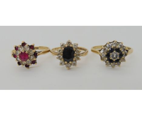 A 9ct gold sapphire and cz flower cluster ring size Q1/2, a further sapphire and cz cluster ring size N1/2, and a red and cle