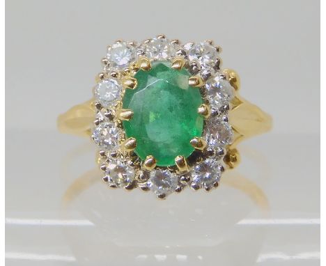 An 18ct gold emerald and diamond cluster ring, set with estimated approx 0.40cts of brilliant cut diamonds, size L1/2, weight