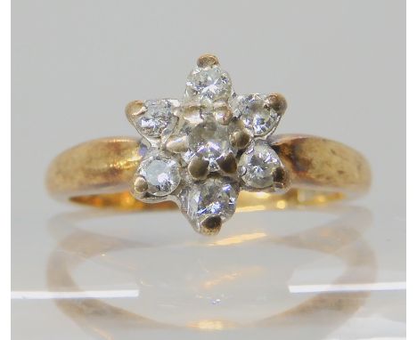 A 9ct gold diamond flower ring set with estimated approx 0.20cts of brilliant cut diamonds, finger size L, weight 2.8gms Cond