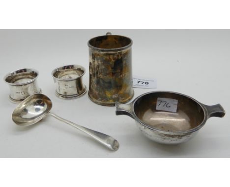 A lot comprising a silver christening mug, Sheffield 1920, a silver ladle, a pair of silver napkin rings and a small quaich (