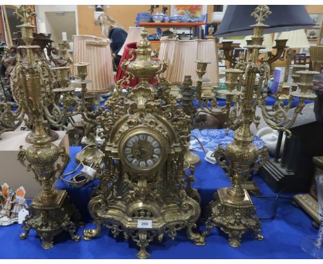 A large gilt metal clock and candelabra garniture, the clock movement marked Germany FHS, clock 60cm high Condition Report: N
