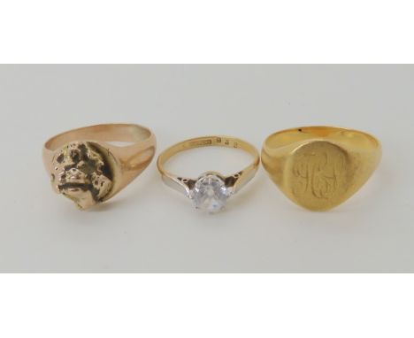 A bright yellow metal signet ring size Q, weight 5.3gms, a yellow metal nugget ring size R1/2 and a clear gem set ring size L