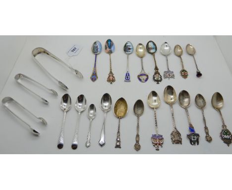 A lot comprising a pair of silver sugar tongs, two more pairs and a collection of mainly silver and enamel souvenir spoons, 3