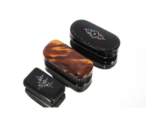 A 19th Century horn and blonde tortoiseshell snuff box, and two papier mache and mother of pearl inlaid snuff boxes, (3)