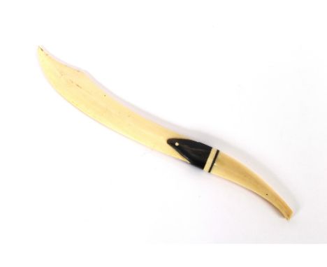 An early 20th Century ivory and horn letter opener, in the form of a scimitar, 27cm long