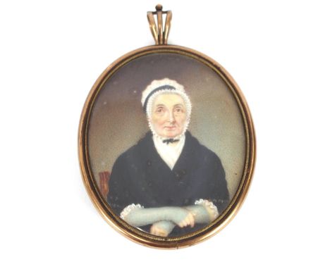 A 19th Century oval miniature portrait, of an elderly lady in black dress and white lace cap, contained in a yellow metal fra