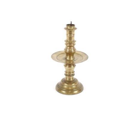 A 16th/17th Century Colonial Dutch turned brass pricket candlestick, with large circular central drip pan, 26cm high