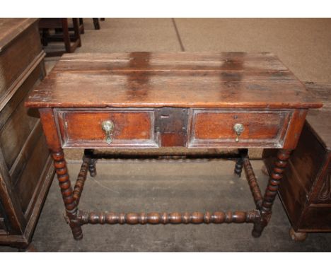 An Antique oak side table, fitted single drawer with iron lock-plate and brass pear-drop handles, raised on barley twist supp