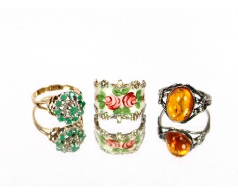 A 9 carat gold two stone emerald and diamond ring; a silver and enamel ring and a silver and amber ring, (3)