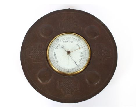 A late 19th Century copper Arts &amp; Crafts barometer, having a white enamel scale plate within a Celtic roundel beaten surr