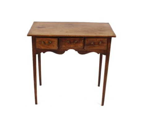 A 19th Century mahogany side table, fitted three drawers above a shaped apron and raised on tapering square section supports,