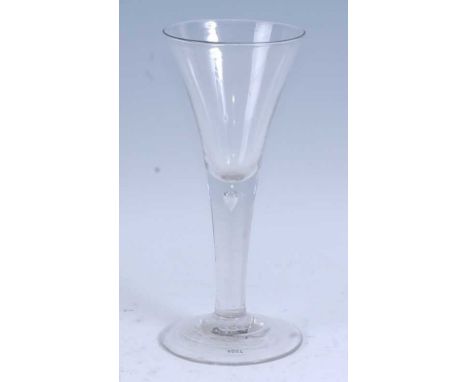 * A circa 1750 oversized wine glass, the drawn trumpet bowl above a teared stem and standing upon a circular foot, 22.5cm hig