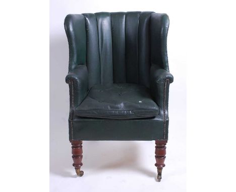 A Victorian mahogany framed and green rexine upholstered tub chair, the ribbed upholstery with brass studs, having slightly a