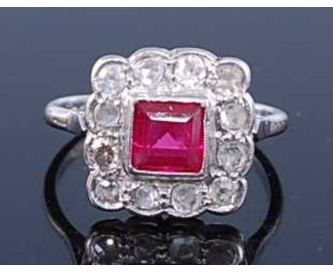 A white metal, ruby and diamond square cluster ring, comprising a square cut ruby surrounded by twelve Old European single ro