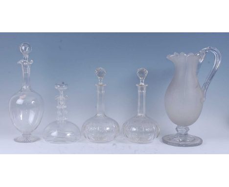 * A pair of Edwardian glass decanters, the faceted ball stoppers above a flat cut neck and squat globular body with star cut 