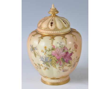 An early 20th century Royal Worcester porcelain blush ivory pot pourri jar and cover, of lobed ovoid form, having pierced gil