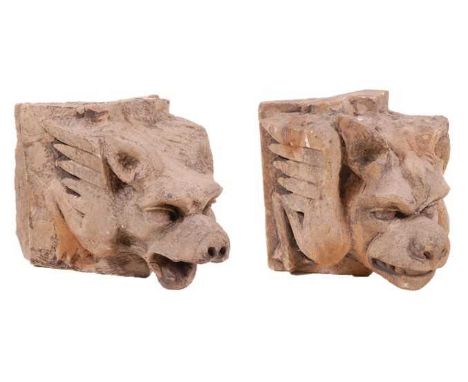 A near-pair of architectural limestone corner blocks, each carved with a wolf like mythical figure, North European Gothic sty