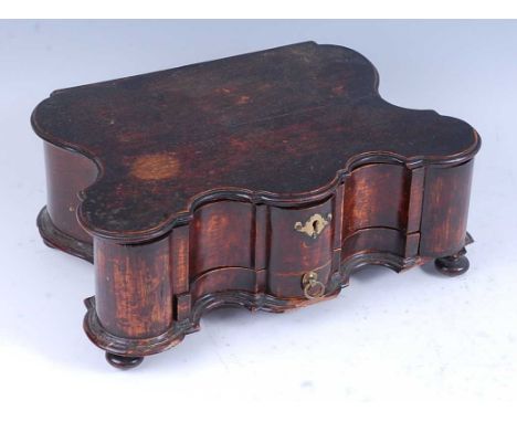 * An early 18th century Dutch chestnut spice box, of cavetto moulded form, the lid lifting to reveal six spice compartments, 