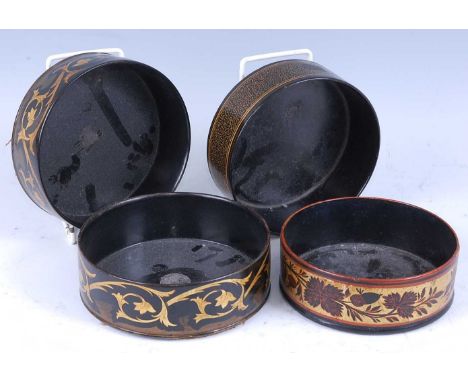 * A pair of George IV papier-mache bottle coasters, each of circular form, the exteriors decorated in gilt with scrolling lea