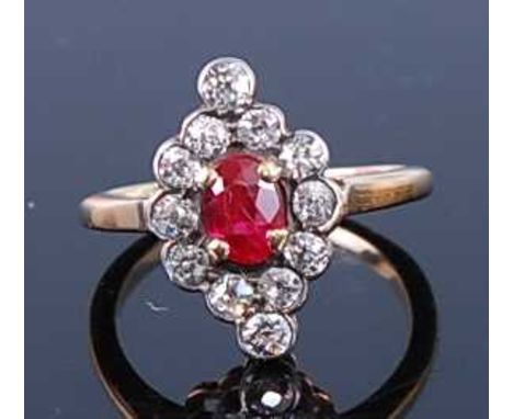 A yellow and white metal, synthetic ruby and diamond navette shaped cluster ring, featuring an oval faceted synthetic ruby in