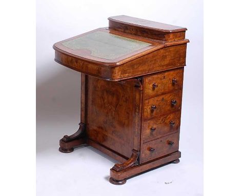 A Victorian figured walnut and burr walnut crossbanded kneehole writing davenport, having a green gilt tooled leather inset w