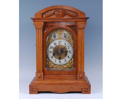 A circa 1900 walnut cased bracket clock, having carved case, brass dial with silvered chapter ring, subsidiary chime/silent a
