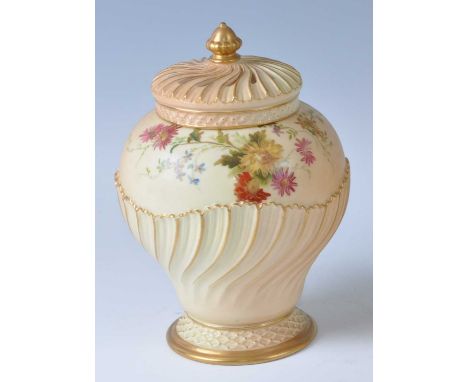 An Edwardian Royal Worcester porcelain blush ivory pot pourri jar and cover, of half swirling gadrooned and lobed form, the u