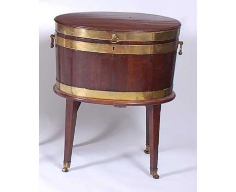 * A Regency coopered mahogany and brass bound wine cooler, having end ring handles, zinc lined fitted interior, and raised on