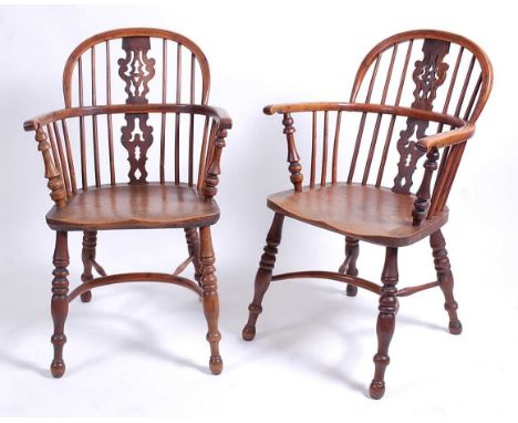 A pair of Victorian elm seat yew wood and fruitwood Windsor chairs, each having pierced vase splatbacks, dish seats, and crin