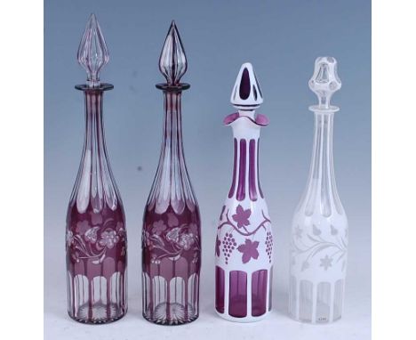 * A Bohemian glass decanter and stopper, purple glass overlaid in white with fruiting vines, h.35cm; together with one other 