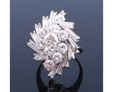 A white metal diamond cocktail ring, featuring eleven round brilliant cut diamonds within a border of fourteen tapered baguet