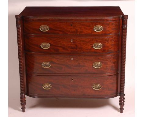 A Regency mahogany bowfront chest, in the manner of Gillows, the top having a reeded edge, proud leaf capped and spiral reede