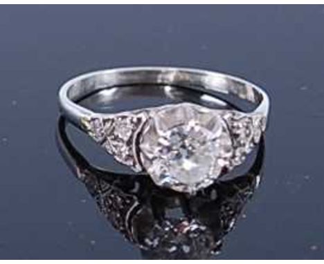 A white metal diamond single stone ring, featuring a round brilliant cut diamond in an eight claw setting, with a trefoil of 