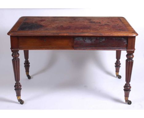 A mid-19th century mahogany writing table in the manner of Gillows, having a gilt tooled leather inset top over twin blind fr