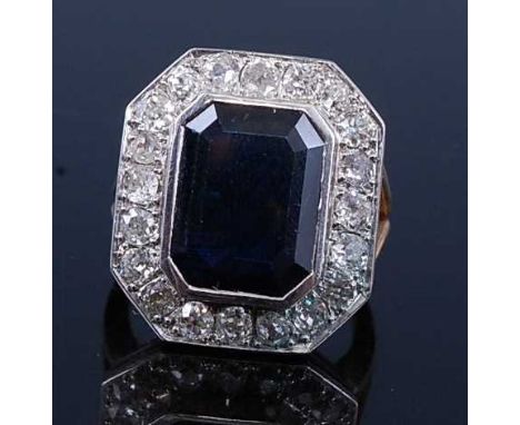 A yellow and white metal, sapphire and diamond octagonal cluster ring, comprising a centre octagonal cut sapphire in a bezel 
