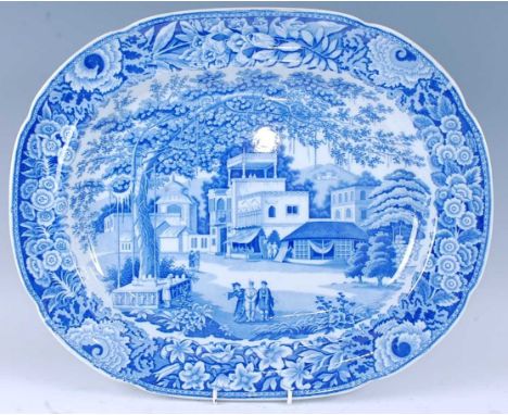 A 19th century blue and white meat plate, decorated with an Indian figure landscape within a floral border, impressed 18 vers