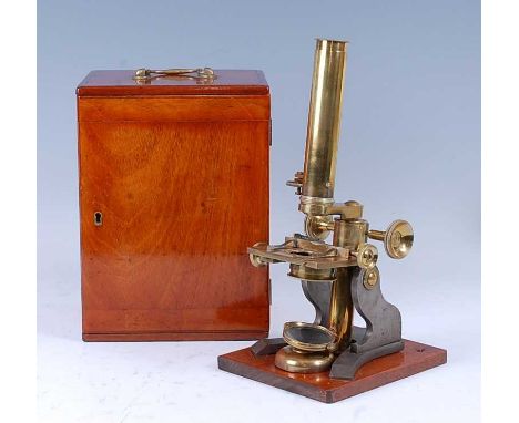 J T Slugg of Manchester - a Victorian brass microscope, having screw-off lens with focus adjustment, lacquered brass mirror r