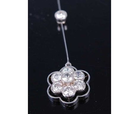 An early 20th century white metal diamond cluster pendant, comprising seven Old European cut diamonds in the shape of a daisy