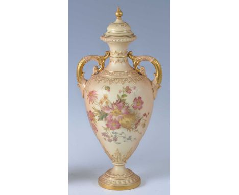 An Edwardian Royal Worcester porcelain blush ivory twin handled pedestal vase and cover, of amphora form with relief moulded 