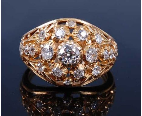A yellow metal diamond bombe shaped cluster ring, having openwork detail, featuring 23 Old European and single cut diamonds i