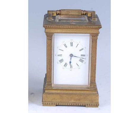 A circa 1900 French lacquered brass carriage clock, having an unsigned white enamel Roman dial with Arabic outer dial, flanke