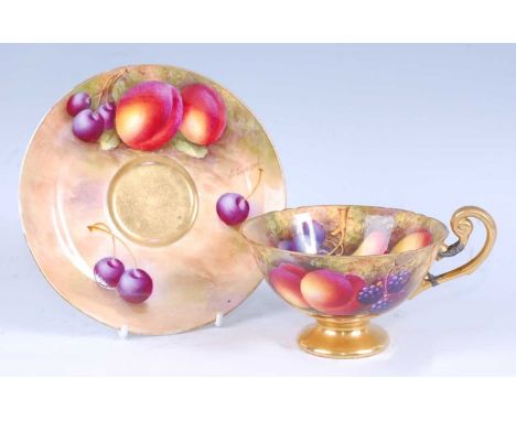 A Royal Worcester porcelain cabinet cup and saucer, decorated with fruit on a mossy bank by E Townsend, signed to the saucer,