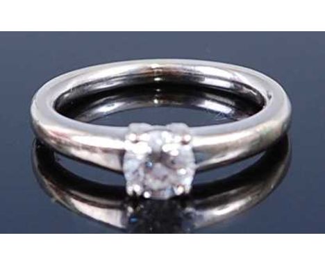 A white metal diamond single stone ring, comprising a round brilliant cut diamond in a four claw setting, diamond dimensions 