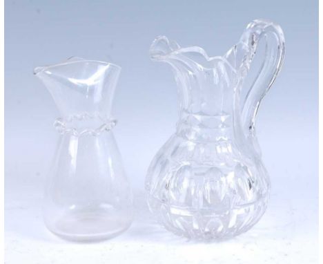 * A George III lead glass water jug, the body with fluted decoration, standing upon a star cut foot, 25cm high, together with