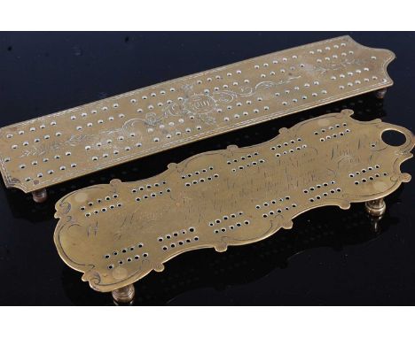 * A George III brass cribbage board, of shaped rectangular form, having engraved C-scroll decoration, the centre engraved wit