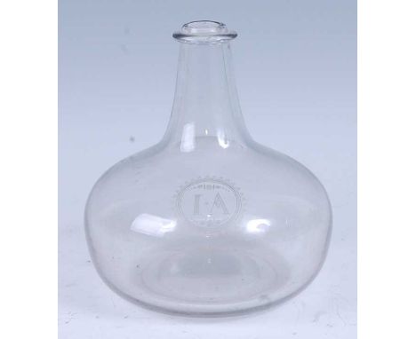 * An early 18th century clear glass wine bottle, of onion form, inscribed 'I A' to the shoulder within cartouche, 18cm highCo