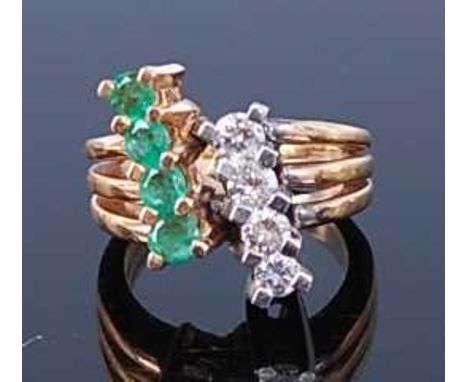 A yellow and white metal, emerald and diamond three strand crossover style ring, featuring four round faceted emeralds and fo