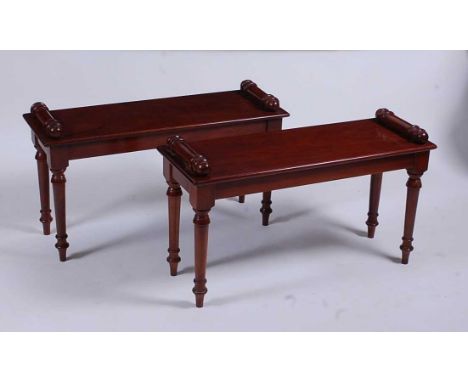 A pair of Victorian style mahogany window seats, each with turned ends and raised on ring turned tapering supports, w.89cm, s