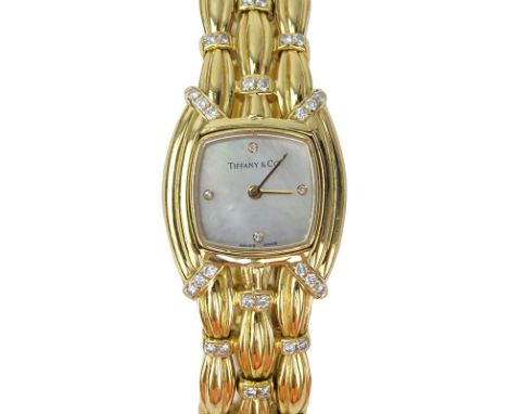 Tiffany & Co 18 Karat Yellow Gold and Diamond Signature Bracelet Watch, Mother of Pearl Dial, Swiss Automatic Movement. Signe