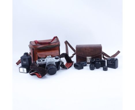 Grouping of Pentax K1000 and Pentax Auto 110 Film Cameras in Leather Traveling Cases. K1000 includes: Minolta auto 128. Auto 